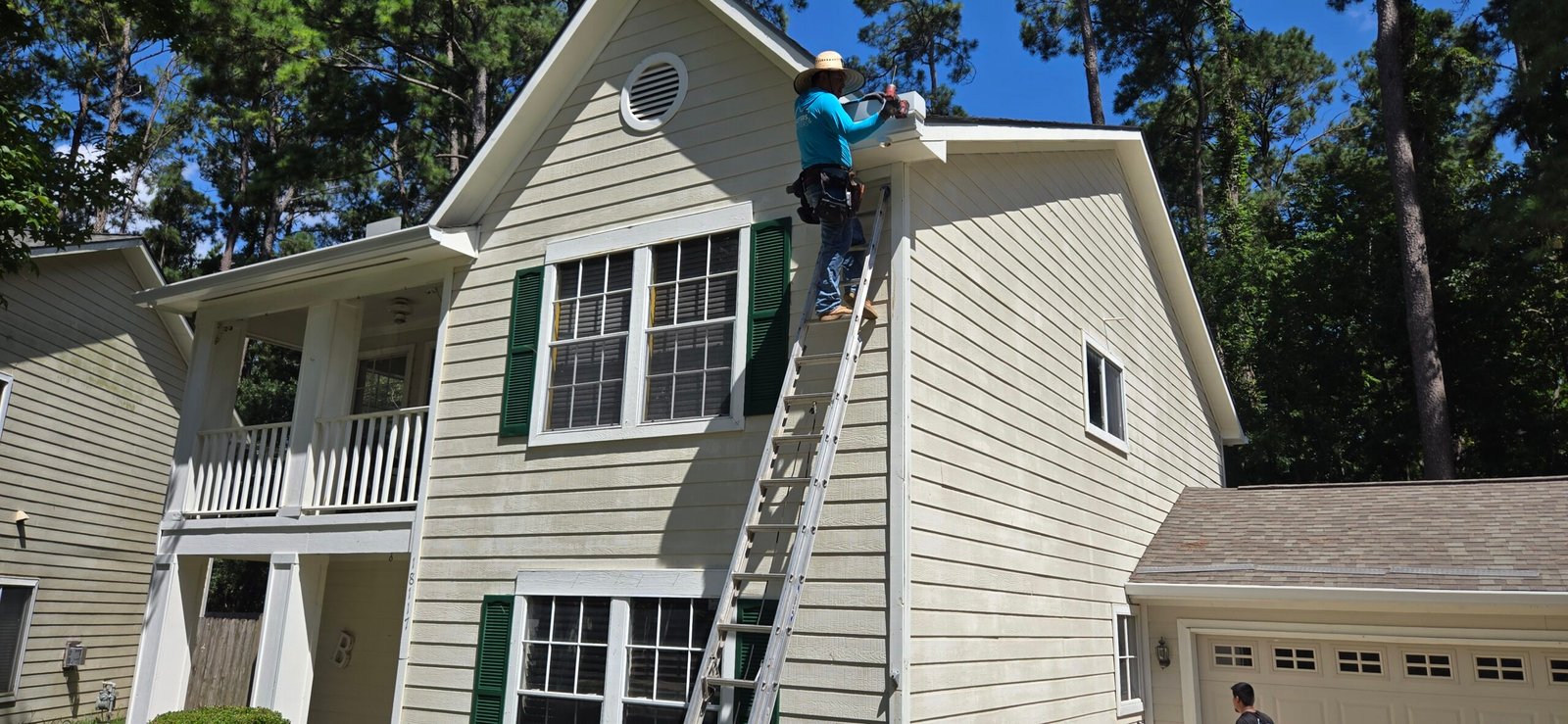 Man on ladder working on house - Gutters and Gutters (gutter cleaning maintenance)