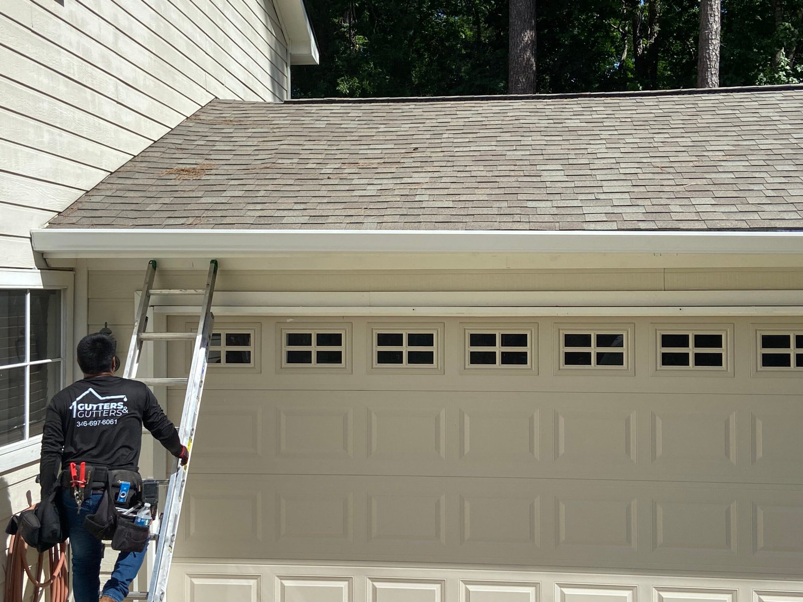 Man on ladder installing gutter - Gutters and Gutters (Best way to install gutters)