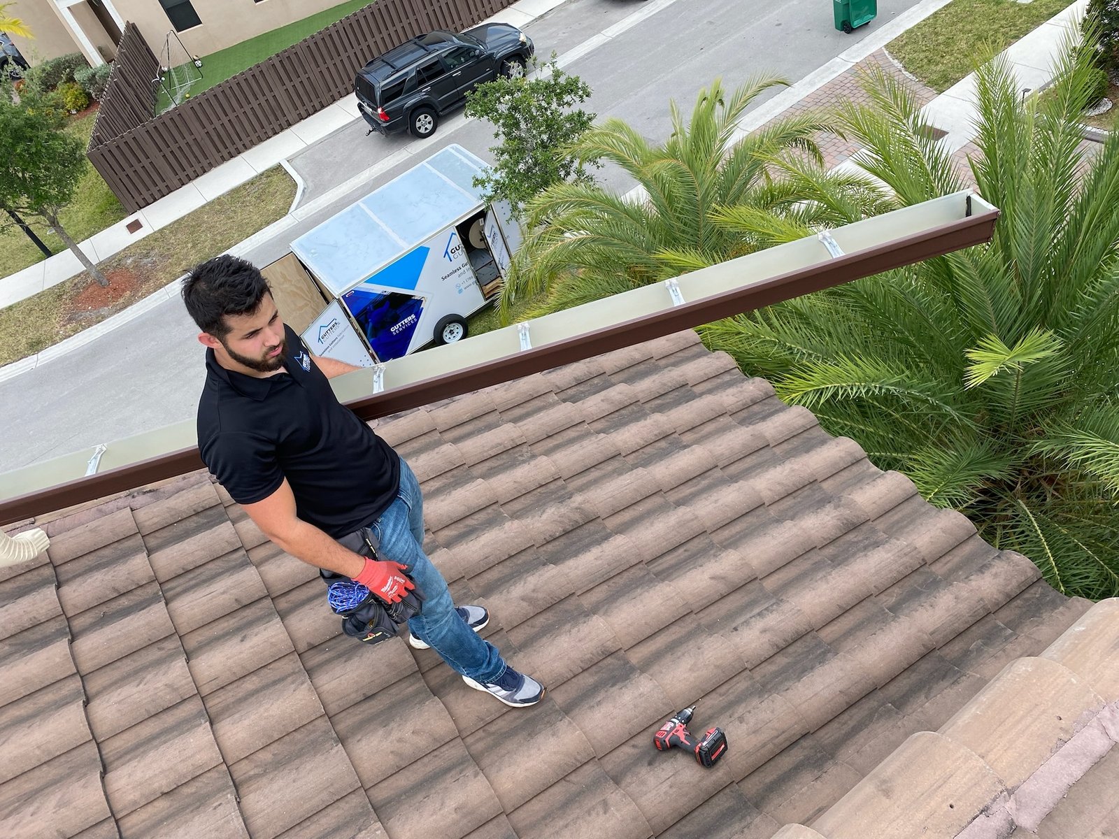 Man installs roof gutter - Gutters and Gutters (commercial gutter repair)